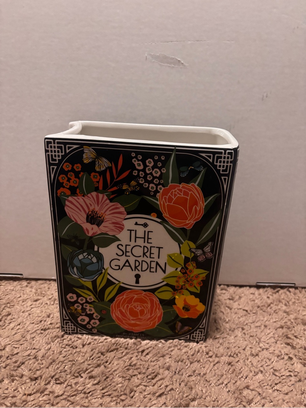 The Secret Garden book shaped vase with floral illustrations and butterflies
